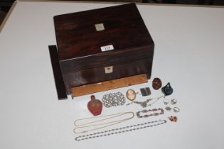 A rosewood and mother of pearl inlaid box with con