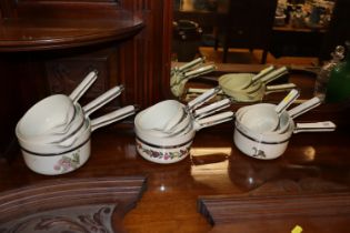 Nine French floral decorated saucepans