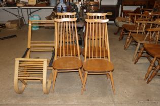 A set of four blond Ercol stick back dining chairs