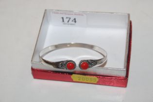 A 925 silver bangle set with red stones