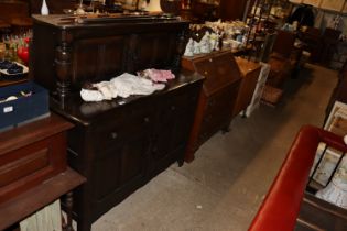 An oak court cupboard fitted two drawers raised on