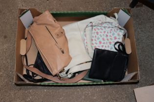 A box containing six leather handbags