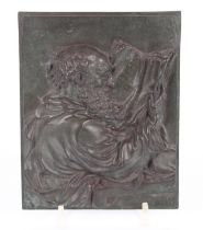 An antique bronze relief plaque depicting an elder