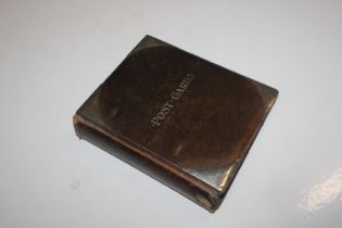 A post-card album with silver mounts containing ap