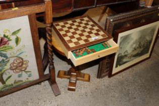 A small oak circular topped side table raised on s