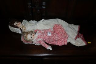 Two porcelain headed dress dolls