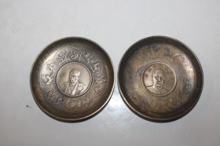 Two white metal dishes inset with coins