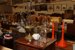 Three oil lamps with glass chimneys