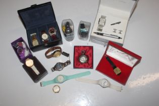 A box containing various wrist watches including g