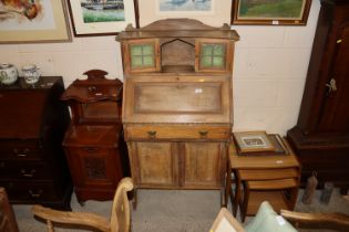 An Edwardian walnut students bureau with leaded gl