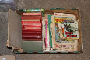A box containing various books and comics