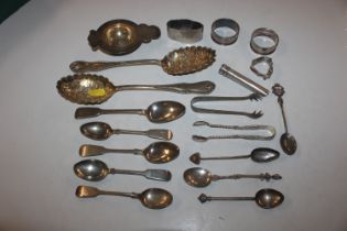 A pair of silver sugar tongs; five various silver