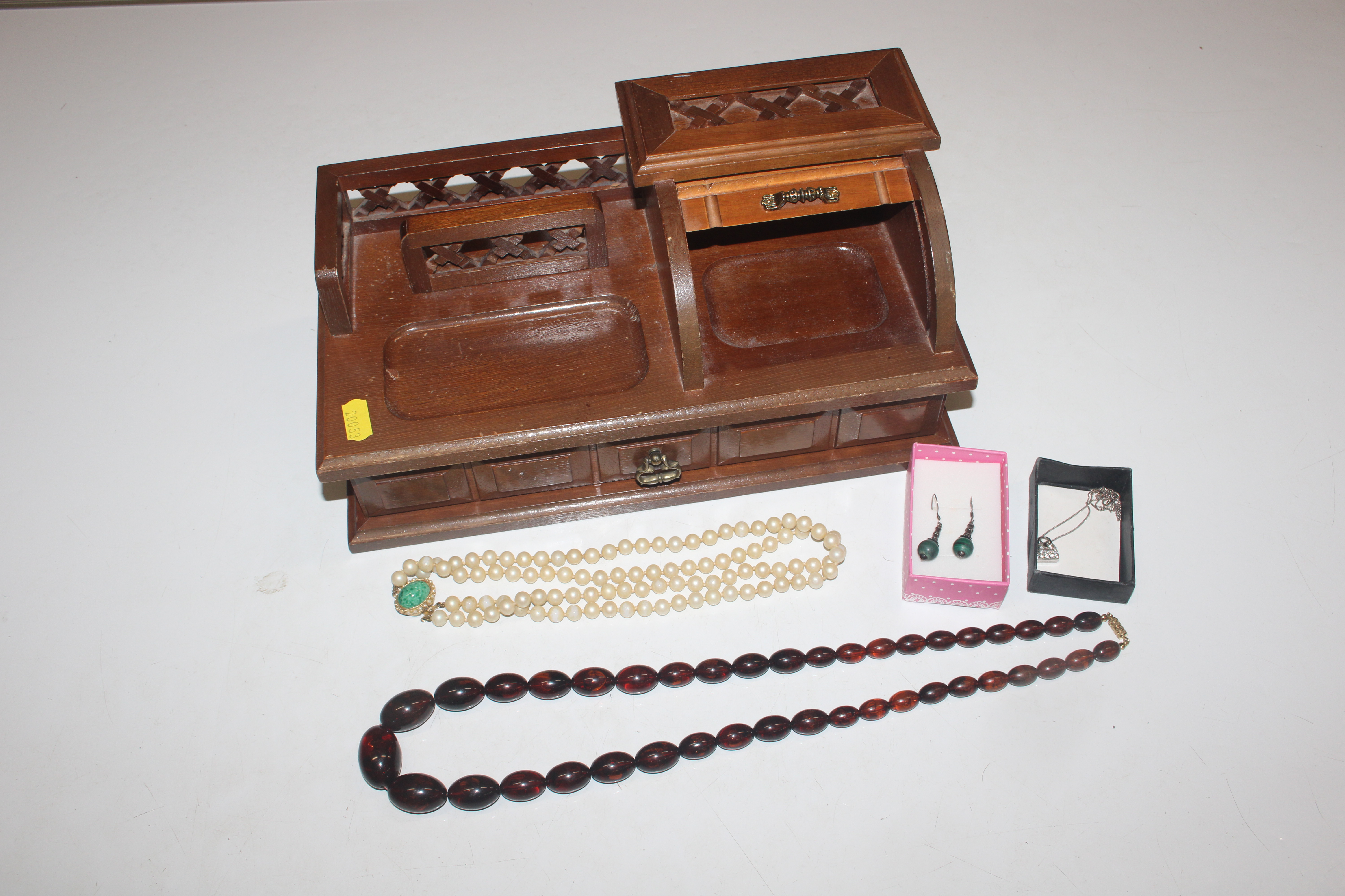 A wooden desk top jewellery box and contents of va