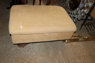 An upholstered foot stool with storage