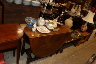 An oak gate leg drop leaf table