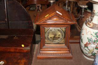 An Edwardian oak cased mantel clock with eight day