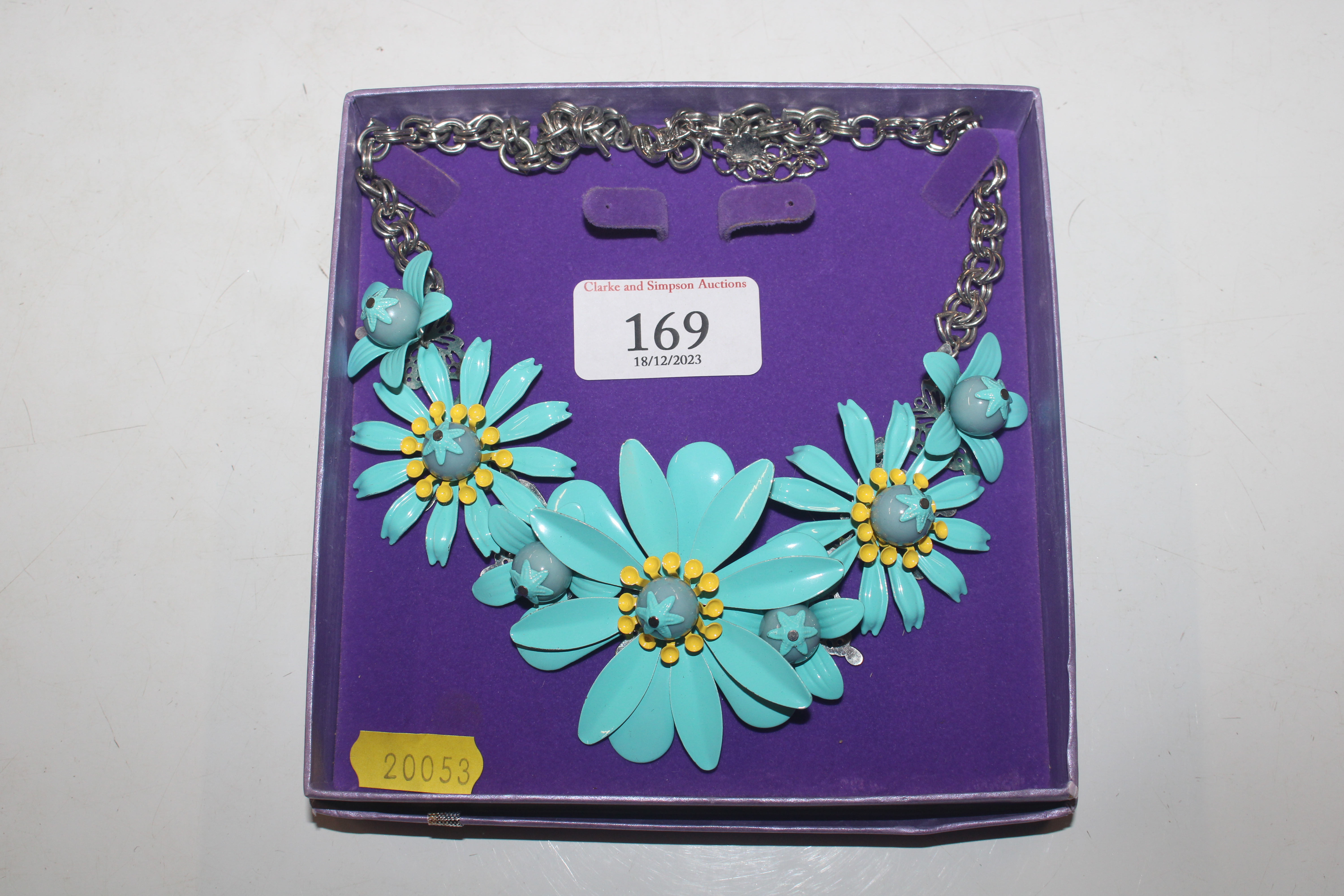 A boxed daisy necklace