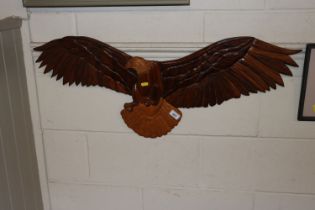 A large carved wooden eagle figure, bears signatur