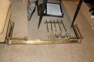 A brass fire curb together with a set of five bras