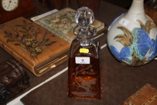 A Bohemian cut glass amber flash decanter decorated game bird design