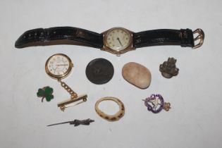 An Accurist wrist watch; a Pulsar watch; badges et