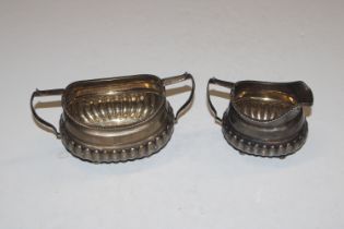 A silver half fluted twin handled sugar bowl and c