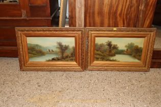 A pair of gilt framed oils on canvas depicting lake scenes