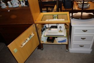 A Riccar 9600 sewing machine in fitted cabinet wit