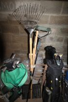 A quantity of long handled tools to include rack,