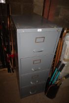 A metal four drawer filing cabinet with key