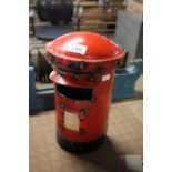 A recycled tin model in the form of a post box/bir