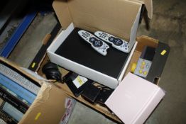A box of various remote controls etc.