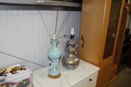 A turquoise glazed pottery table lamp with cherub