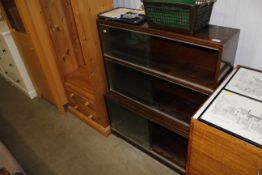 A vintage style three section bookcase enclosed by