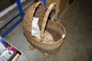 A wicker basket and contents of various dolls