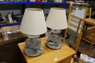 A pair of kickstand design table lamps and shades