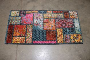 An approx. 4'5" x 2'3" patterned wool rug