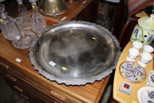 A large circular plated tray with floral border