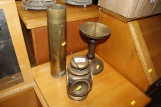 A vintage brass shell case, a brass pricket candle