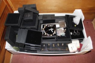 A box of miscellaneous costume jewellery, empty je