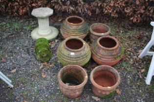 A set of three ribbed terracotta plant pots, three