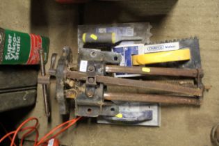 A Woden bench vice and three plasterers trowels