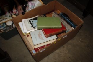 A box of miscellaneous books including 'The Man Wi