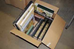 A box of various books including Atlas's