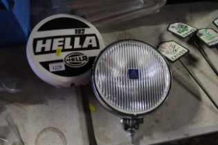 A Hella halogen car spotlight with cover