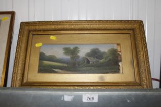 A small gilt framed oil on board of a cottage