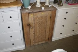 A stripped pine cupboard