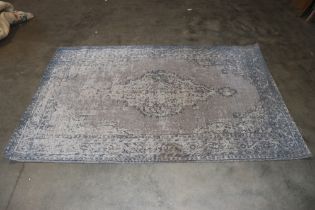 An approx. 7'10" x 5'3" patterned rug