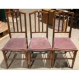 Three mahogany ladder back dining chairs with purple padded seats