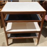 Two oak framed, white laminate topped, occasional tables with undertiers,
